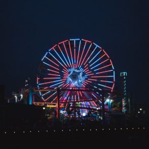 illuminated ferris wheel in amusement park at night